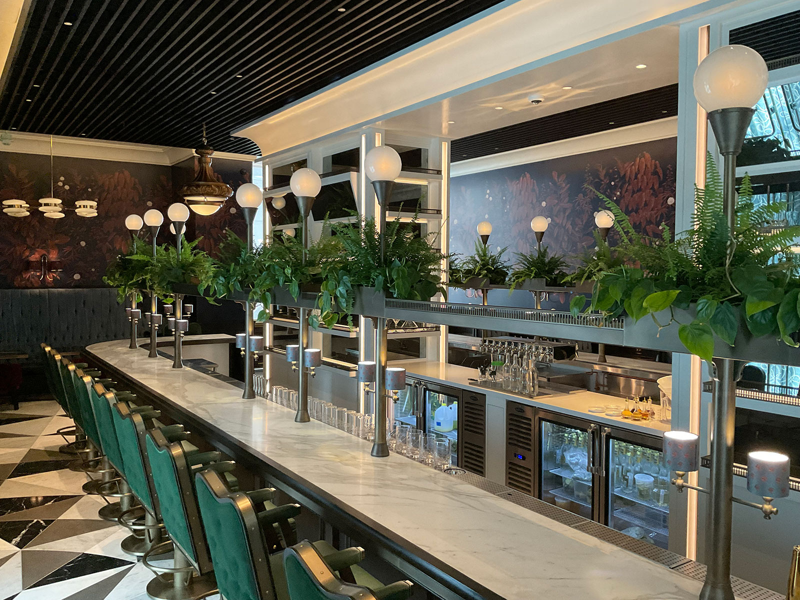 Long bar with metal posts, rail, and overhead steel