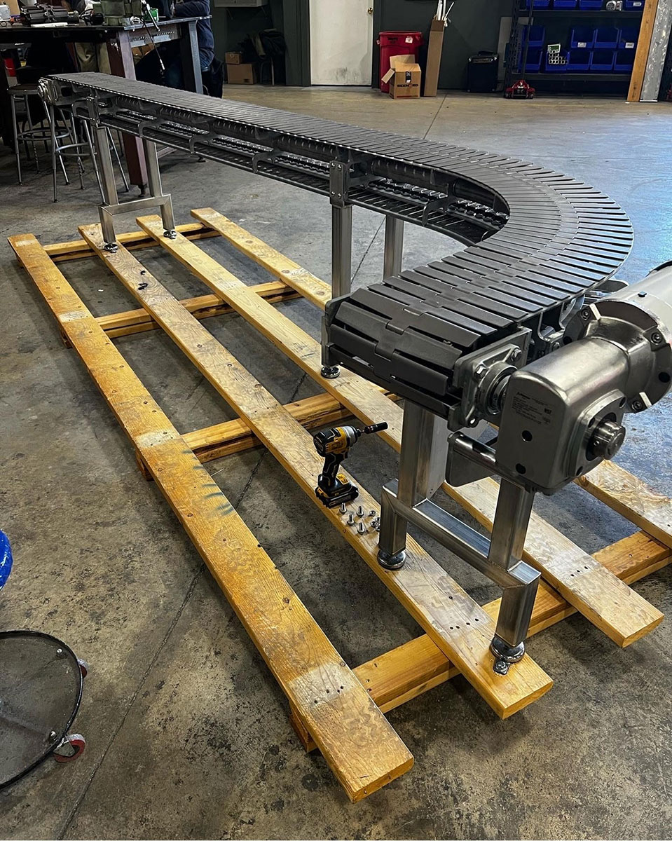 Curved conveyor section on a stainless support frame
