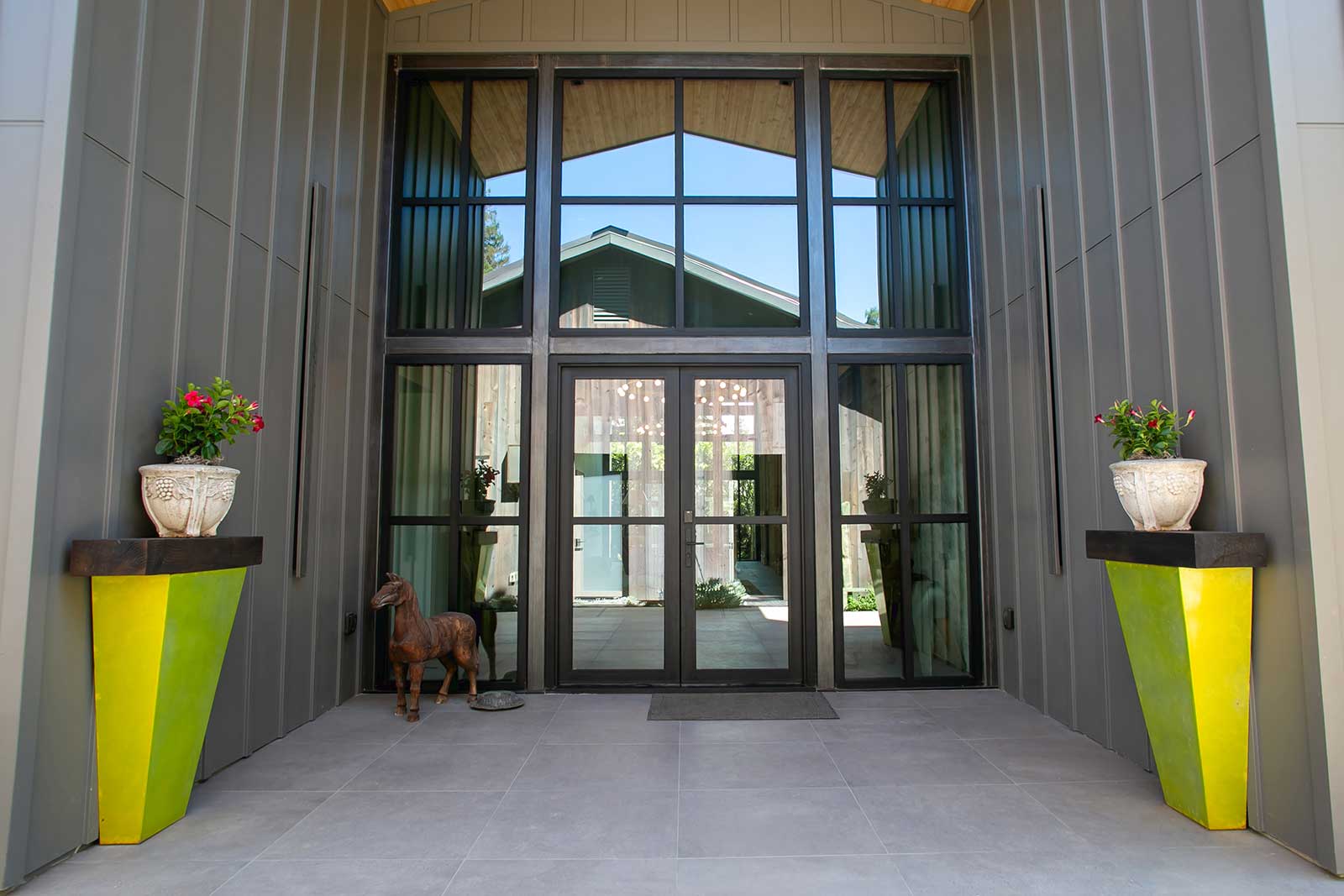 Steel-framed glass entry with metal wall panels